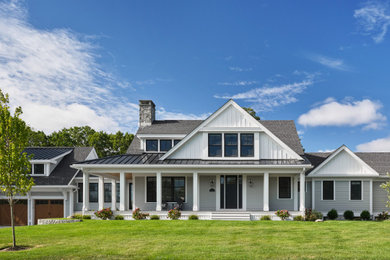 Example of a mid-sized farmhouse gray two-story board and batten exterior home design in Boston with a mixed material roof and a black roof