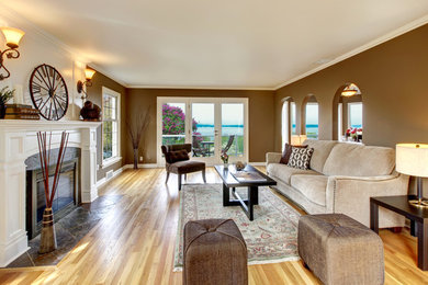 Elegant living room photo in San Diego with brown walls and a standard fireplace