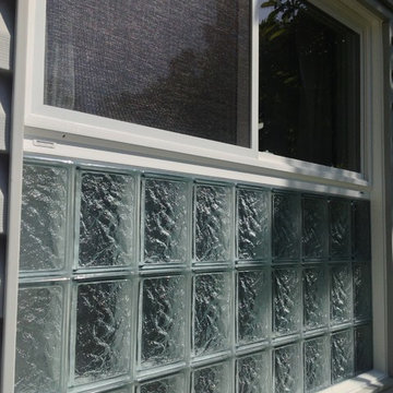 Close up of glass block window with vinyl sliding glass