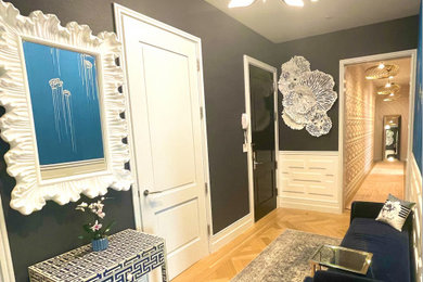 Inspiration for an eclectic light wood floor and beige floor entryway remodel in New York with blue walls and a black front door