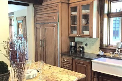 Elegant l-shaped kitchen photo in Cleveland with recessed-panel cabinets, medium tone wood cabinets and an island