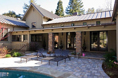 Example of a huge eclectic beige one-story wood exterior home design in San Francisco with a metal roof