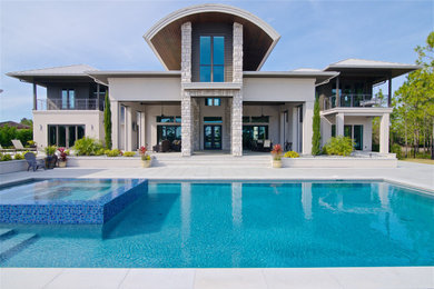 Contemporary beige two-story house exterior idea in Jacksonville with a metal roof
