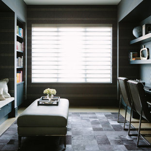 Design ideas for a large modern study in Chicago with multi-coloured walls, medium hardwood flooring, a built-in desk and brown floors.