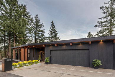 Large mid-century modern attached garage photo in Portland