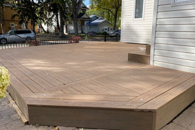 Example of a mid-sized trendy backyard ground level deck design in Edmonton