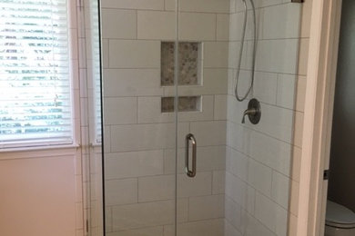 Inspiration for a mid-sized transitional master white tile and ceramic tile porcelain tile corner shower remodel in Charlotte with white cabinets