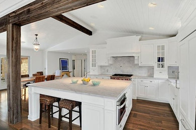 Inspiration for a large modern galley dark wood floor eat-in kitchen remodel in Newark with a single-bowl sink, shaker cabinets, white cabinets, marble countertops, white backsplash, ceramic backsplash, stainless steel appliances and an island