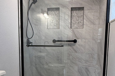 Small minimalist master gray tile and porcelain tile porcelain tile, multicolored floor and single-sink sliding shower door photo in Tampa with shaker cabinets, gray walls, marble countertops, white countertops, a niche and a freestanding vanity