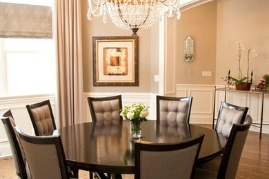 Photo of a mid-sized traditional separate dining room in Chicago with beige walls, medium hardwood floors and no fireplace.