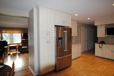 Inspiration for a large timeless u-shaped ceramic tile eat-in kitchen remodel in Cleveland with white cabinets, stainless steel appliances, gray backsplash, shaker cabinets, no island, granite countertops and subway tile backsplash