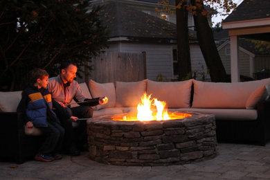 Mid-sized modern backyard patio in Boston with a fire feature, concrete pavers and no cover.