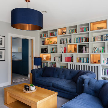 LUXURY FULLY FITTED LIVING ROOM WITH BESPOKE BOOKCASES AND MEDIA WALL