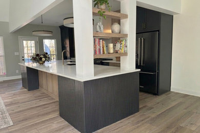 Example of a large transitional eat-in kitchen design in Charlotte with recessed-panel cabinets, light wood cabinets, quartz countertops, white backsplash, quartz backsplash, an island and gray countertops
