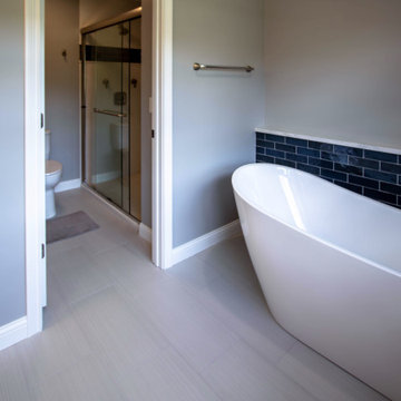 Primary Bathroom with Blue-Gray Vanity and Deep Blue Tiled Feature Wall
