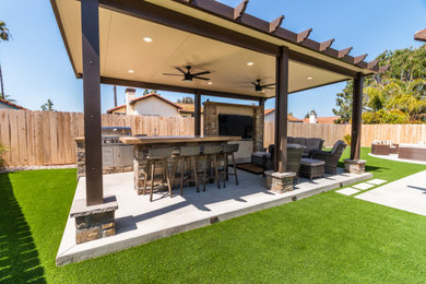 Example of a classic backyard patio kitchen design in San Diego