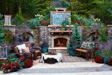 Large mountain style backyard concrete paver patio photo in DC Metro with a fire pit
