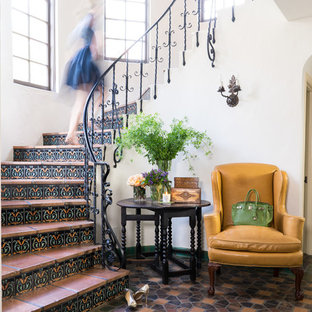 Design ideas for a mediterranean curved metal railing staircase in San Francisco with tiled risers and terracotta treads.