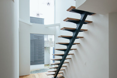 Design ideas for a large urban wood floating staircase in Other.