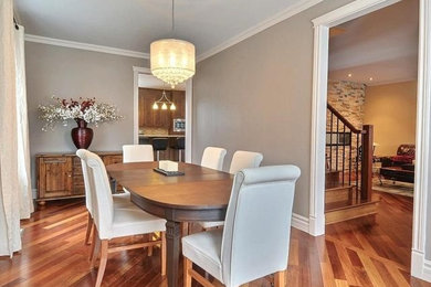 Enclosed dining room - large contemporary medium tone wood floor enclosed dining room idea in Montreal with gray walls
