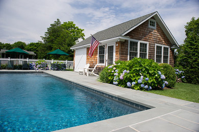 Inspiration for a large timeless backyard stone and rectangular lap pool house remodel in New York