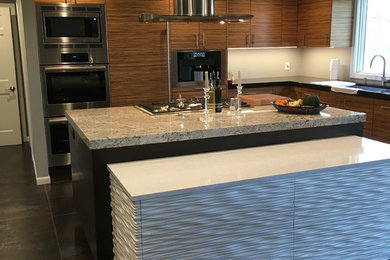 Inspiration for a mid-sized modern galley ceramic tile and black floor eat-in kitchen remodel in Other with a double-bowl sink, flat-panel cabinets, distressed cabinets, granite countertops, stainless steel appliances and two islands
