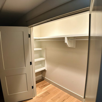 Elegant Hall Closet Organization: White Built-Ins, Open Cubbies, and Hanging St