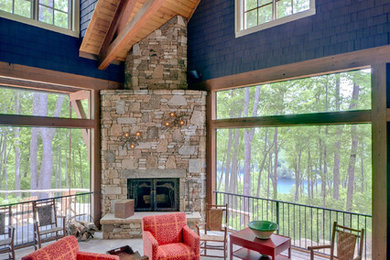 Inspiration for a large rustic stone side porch remodel in Other with a fire pit and a roof extension