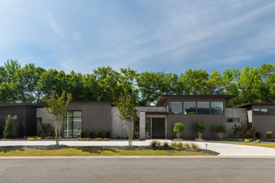 Example of a large trendy gray one-story wood exterior home design in Other with a shingle roof and a black roof