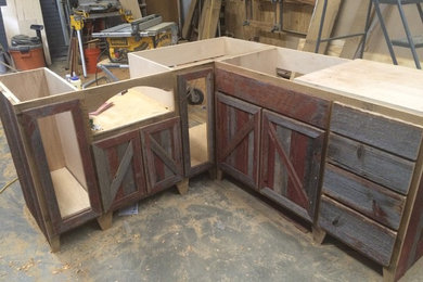 Large mountain style l-shaped eat-in kitchen photo in Other with raised-panel cabinets and distressed cabinets