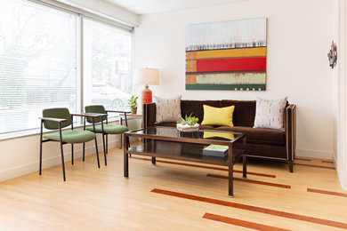 Example of a trendy laminate floor living room design in Salt Lake City with white walls