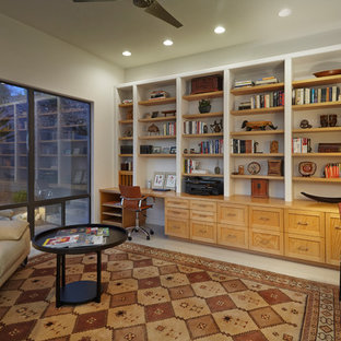 Photo of a medium sized modern home office and library in Phoenix with white walls, porcelain flooring, a built-in desk and white floors.