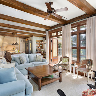 Photo of a medium sized mediterranean formal open plan living room in Miami with green walls, no tv, medium hardwood flooring, a standard fireplace, a concrete fireplace surround and brown floors.