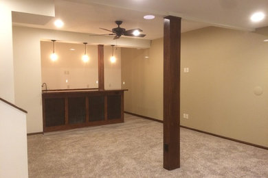 Mid-sized arts and crafts underground carpeted basement photo in Other with beige walls