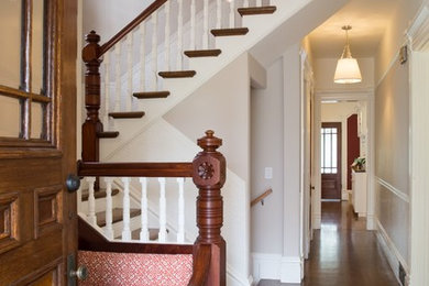 Example of a classic medium tone wood floor entryway design in San Francisco with beige walls and a medium wood front door