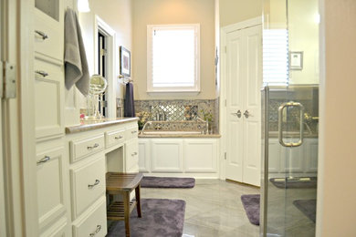 Mid-sized traditional master bathroom in New Orleans with white cabinets, beige walls, recessed-panel cabinets, an undermount tub, an alcove shower, beige tile, gray tile, mosaic tile, porcelain floors, an undermount sink, granite benchtops, grey floor and a hinged shower door.