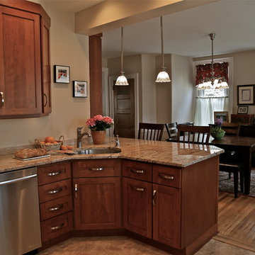 Warm Wood Kitchen Remodel | Angled Granite Island & Integrated Display Cabinets
