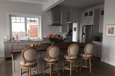 Mid-sized trendy dark wood floor eat-in kitchen photo in Providence with an undermount sink, shaker cabinets, gray cabinets, wood countertops, stainless steel appliances and an island