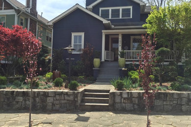 Example of a mid-sized classic blue two-story vinyl house exterior design in Atlanta with a clipped gable roof and a shingle roof