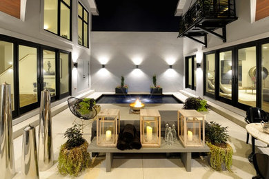 Mid-sized minimalist backyard concrete and rectangular pool fountain photo in St Louis