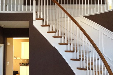 Inspiration for a large timeless wooden curved wood railing staircase remodel in Philadelphia with wooden risers
