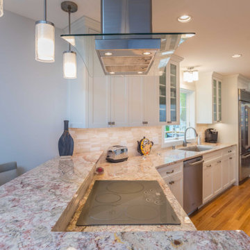 Modern Kitchen with White Flat Panel Shaker Cabinets & Natural Stone Backsplash