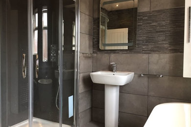 Small contemporary ensuite bathroom in Other with beaded cabinets, white cabinets, a freestanding bath, a walk-in shower, a two-piece toilet, grey tiles, porcelain tiles, grey walls, porcelain flooring, a pedestal sink, grey floors and a sliding door.