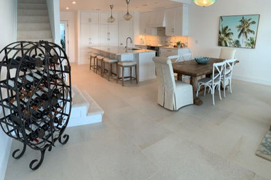 Example of a mid-sized transitional open concept porcelain tile and beige floor family room design in Miami with white walls