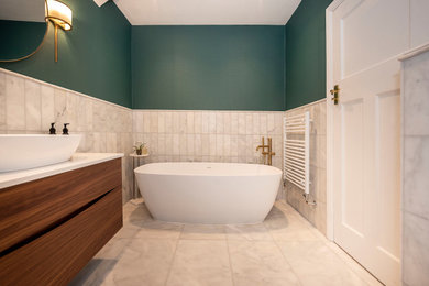 Inspiration for a small classic ensuite bathroom in London with medium wood cabinets, a freestanding bath, grey tiles, marble tiles, green walls, marble flooring, quartz worktops, grey floors, white worktops, a dado rail, a single sink, a floating vanity unit and wallpapered walls.