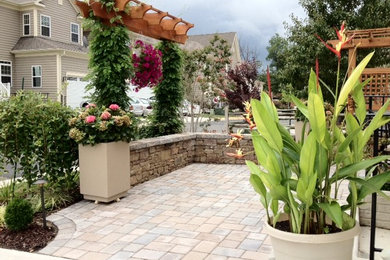 Mid-sized elegant courtyard stone patio container garden photo in DC Metro with a gazebo