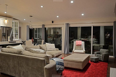 Living room - large contemporary formal and open concept dark wood floor and brown floor living room idea in Los Angeles with beige walls, a standard fireplace, a stone fireplace and a wall-mounted tv