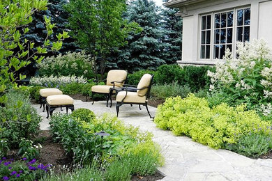 Inspiration for a mid-sized traditional full sun courtyard stone landscaping in Toronto.