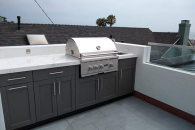 Inspiration for a mid-sized coastal rooftop rooftop glass railing outdoor kitchen deck remodel in Los Angeles