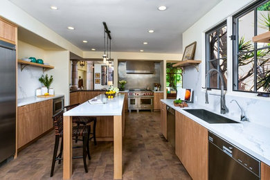 This is an example of a large contemporary galley kitchen in Santa Barbara with with island and brown floor.